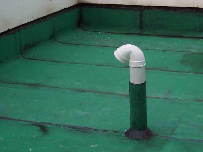 Seamless polyurea waterproofing membrane sealing a rooftop pipe penetration